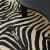 Zebra Print Cowhide Rug Beige Under Round Black Coffee Table